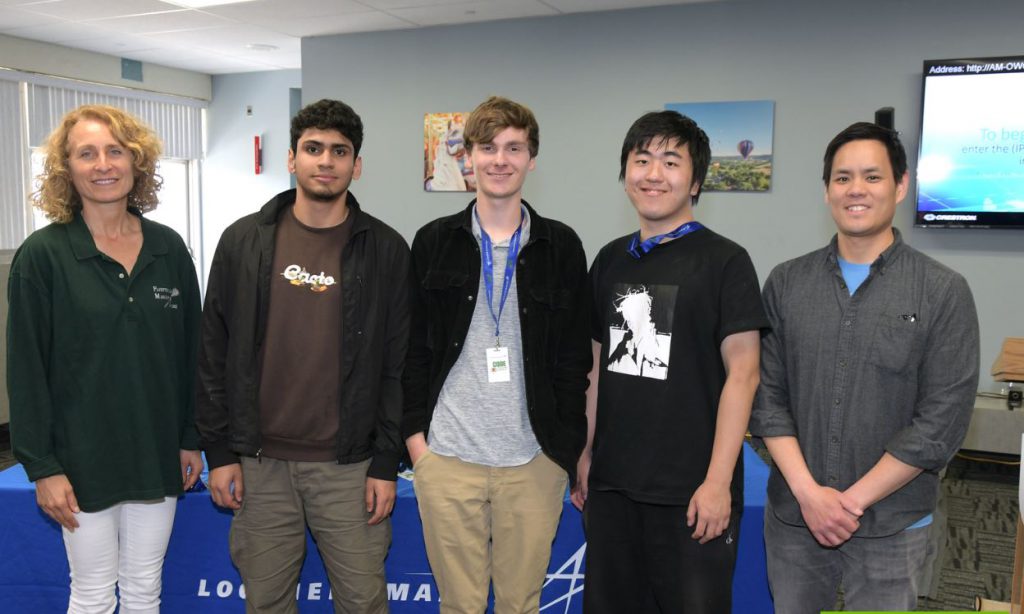 A group photo of the founr senior team members at Code Quest with their advisor