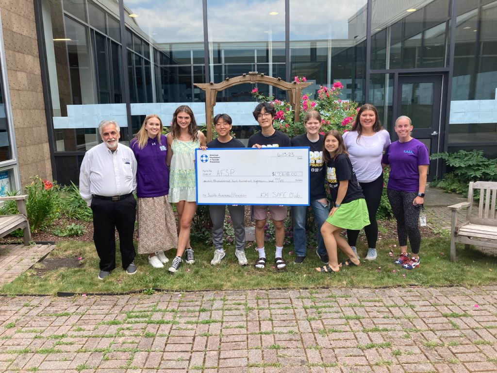 A photo of students holding a large check