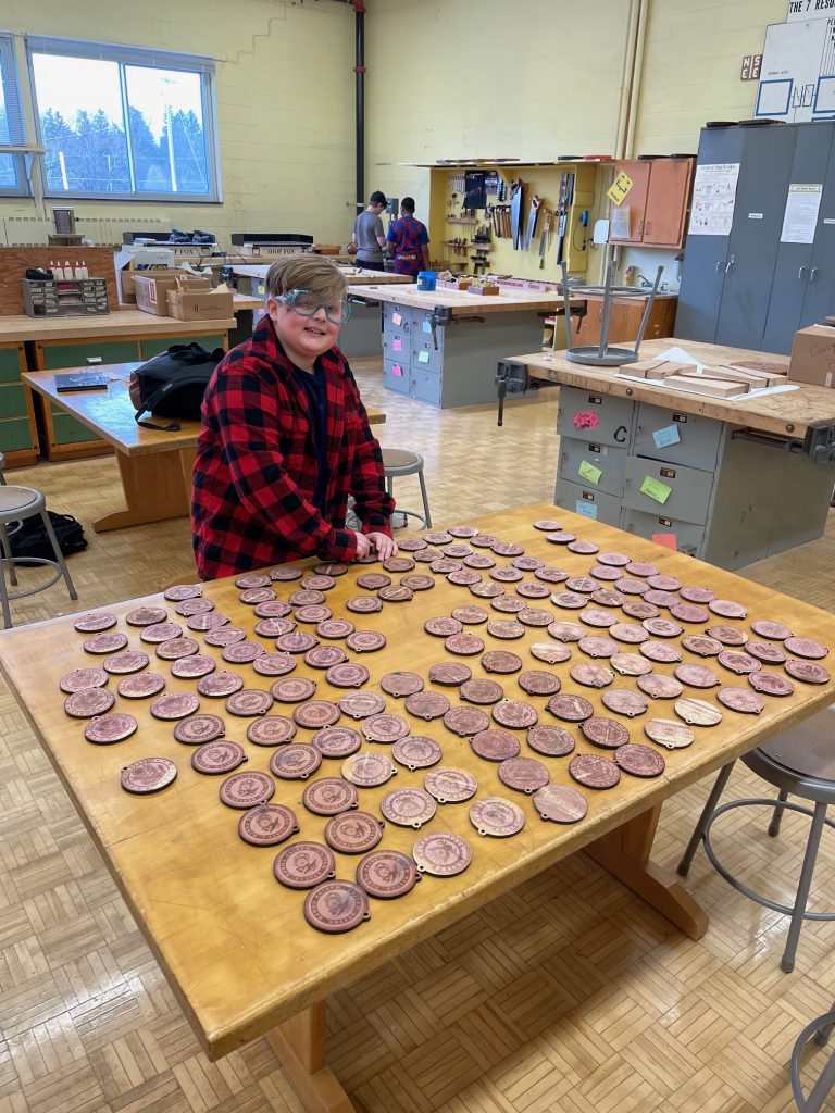 7th grader Colton Jaconski helps sand ornaments to be donated to Syracuse's VA hospital.