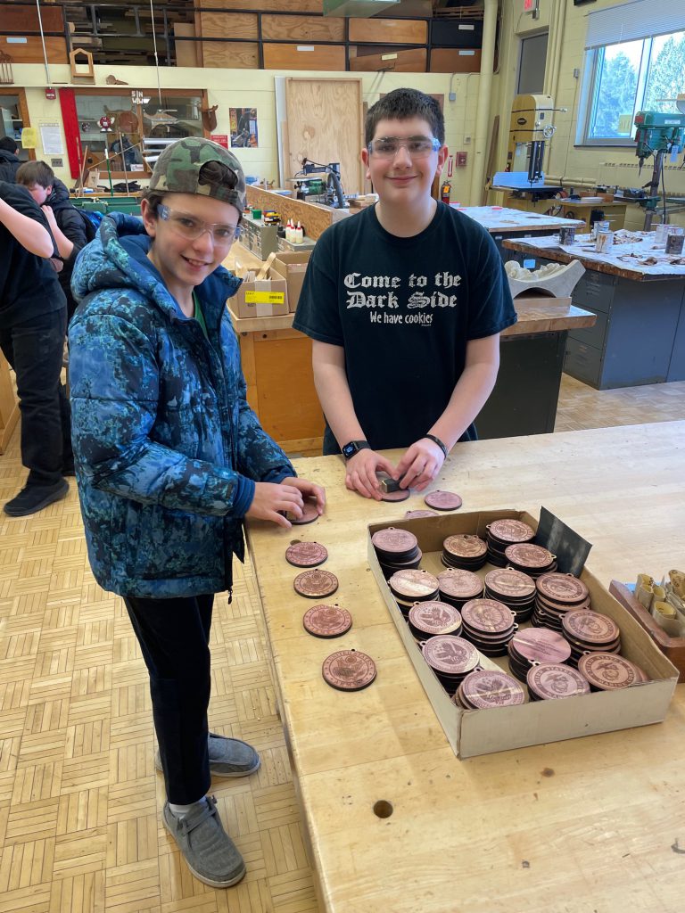 7th graders Roman Darius (L) and Drake Broad (R) help sand ornaments to be donated to Syracuse's VA hospital.