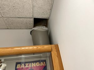 A leak in the roof at high school has forced a garbage can to be placed on a display case in the second floor science hallway.