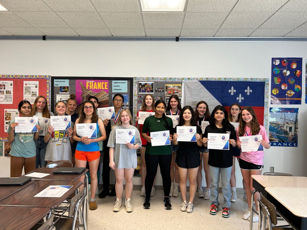 French 3 Honors students celebrate successful scores on their exams.