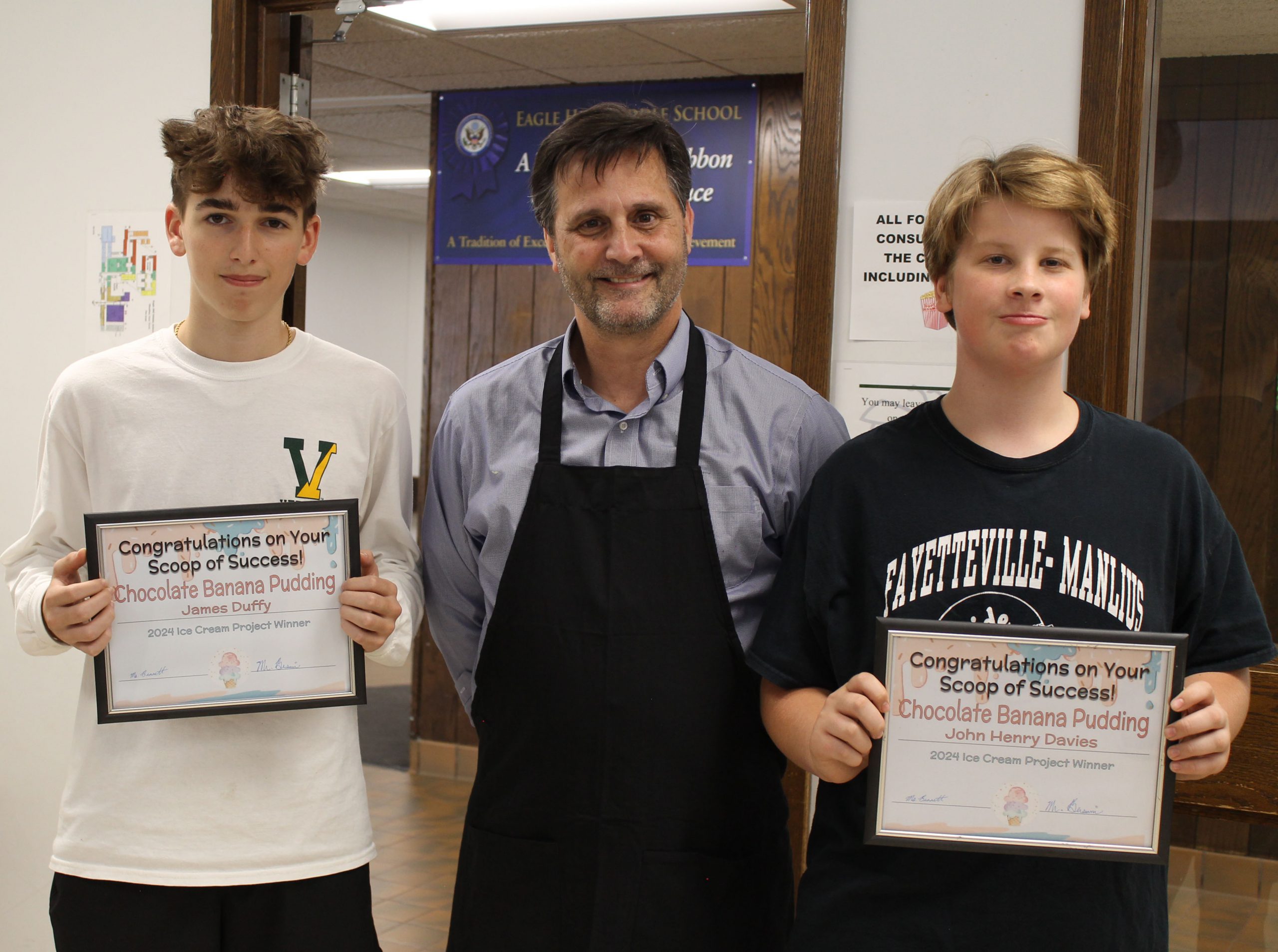 John Henry Davies and James Duffy holding framed certificates and standing next to Matt Monroe