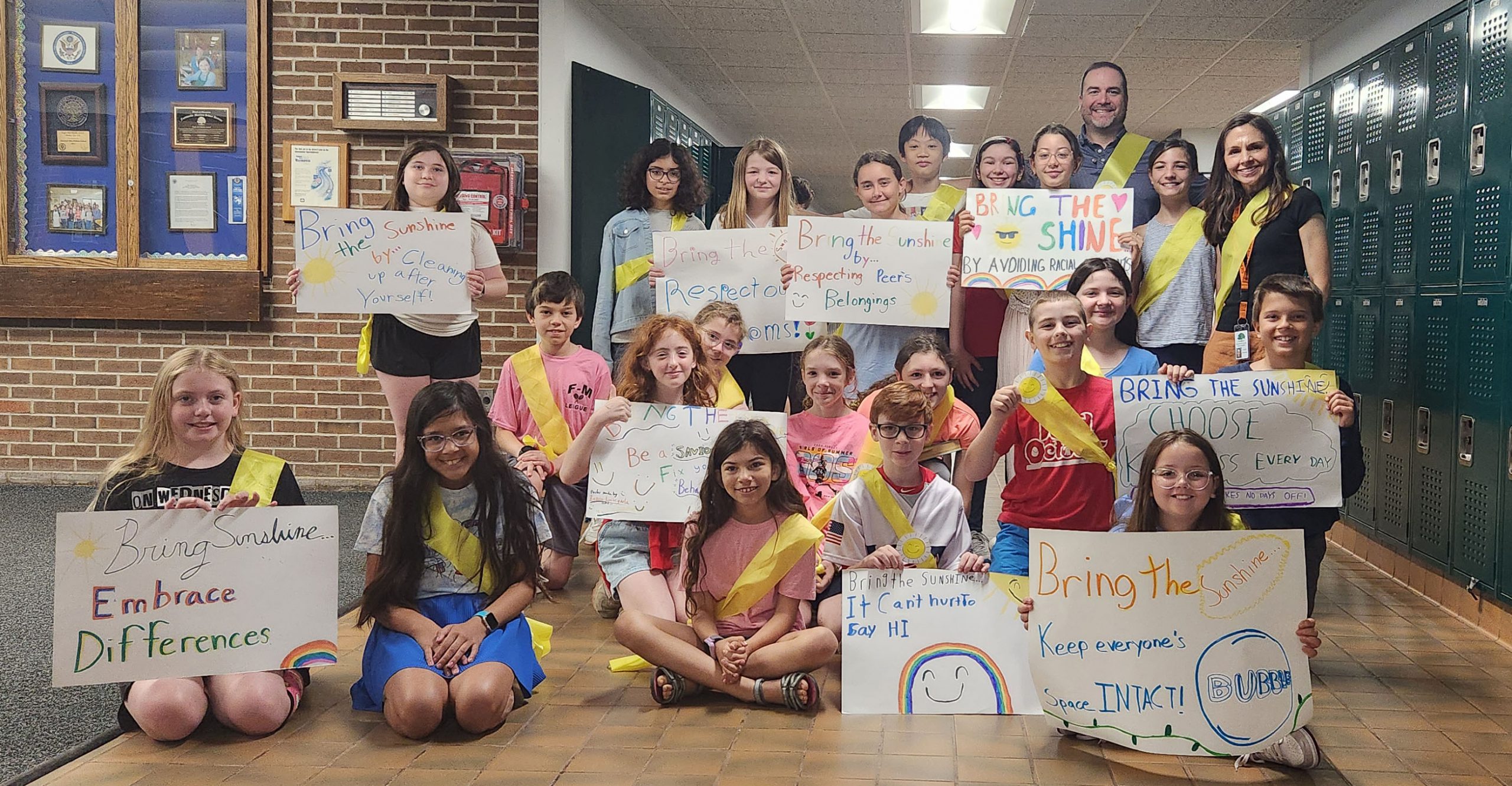 group of Sunshine Ambassadors holding posters and smiling