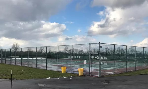 The outside of a tennis field.