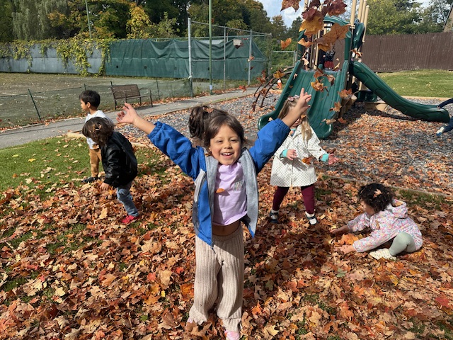 young students playing outside