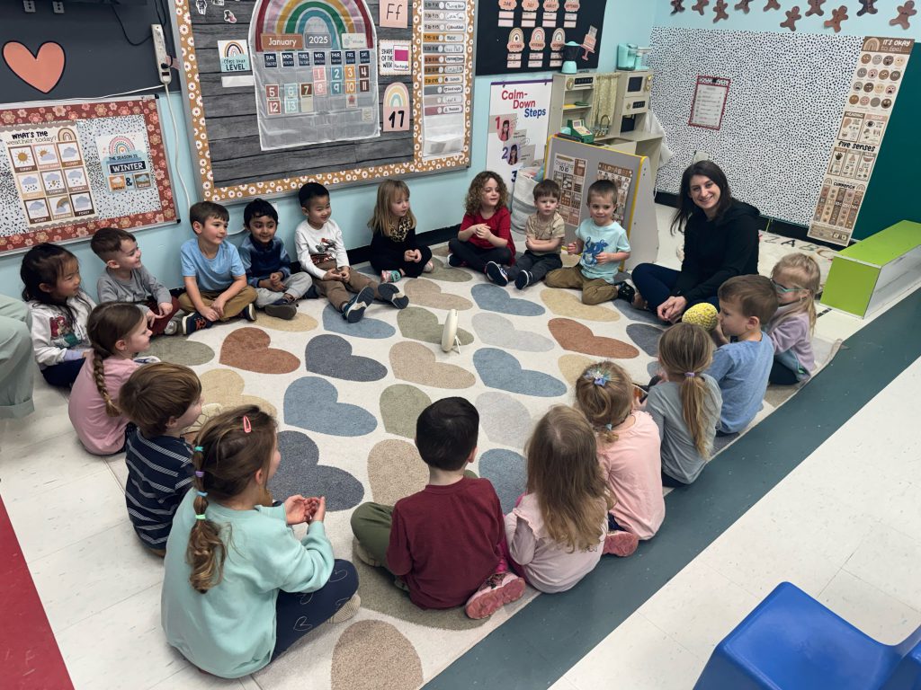 young students in class sitting in circle