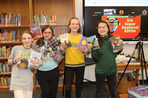 Eagle Hill Middle School students on team "Book Cats" hold books ahead of the Super Regional Competition.