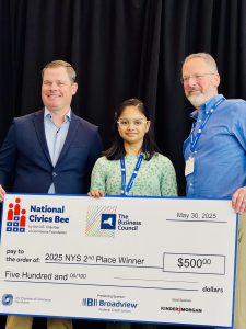 F-M student holds a big check.