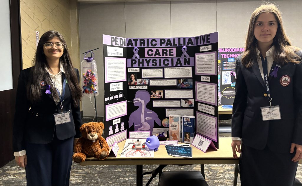 Two F-M students stand in front of a poster at HOSA Spring Leadership Conference.