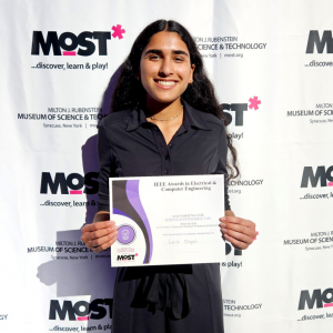 FMHS student Laila Duggal holds up a certificate at the CNY Science and Engineering Fair.
