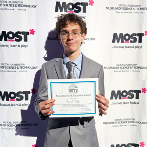 FMHS student Yusuf Ay holds up a certificate at the CNY Science and Engineering Fair.