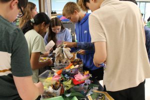 Students dig through bins of fabric