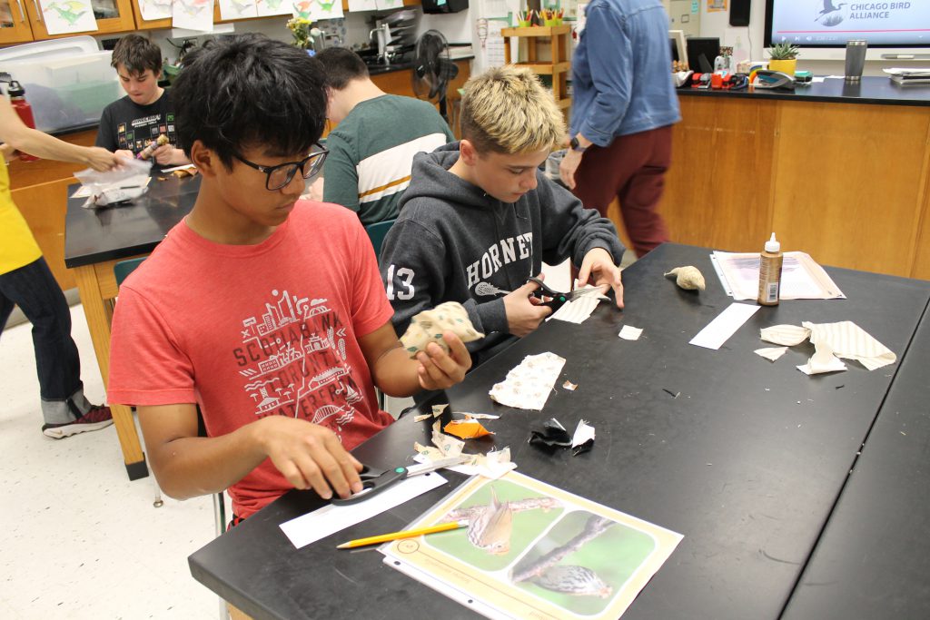Two students work on art projects.