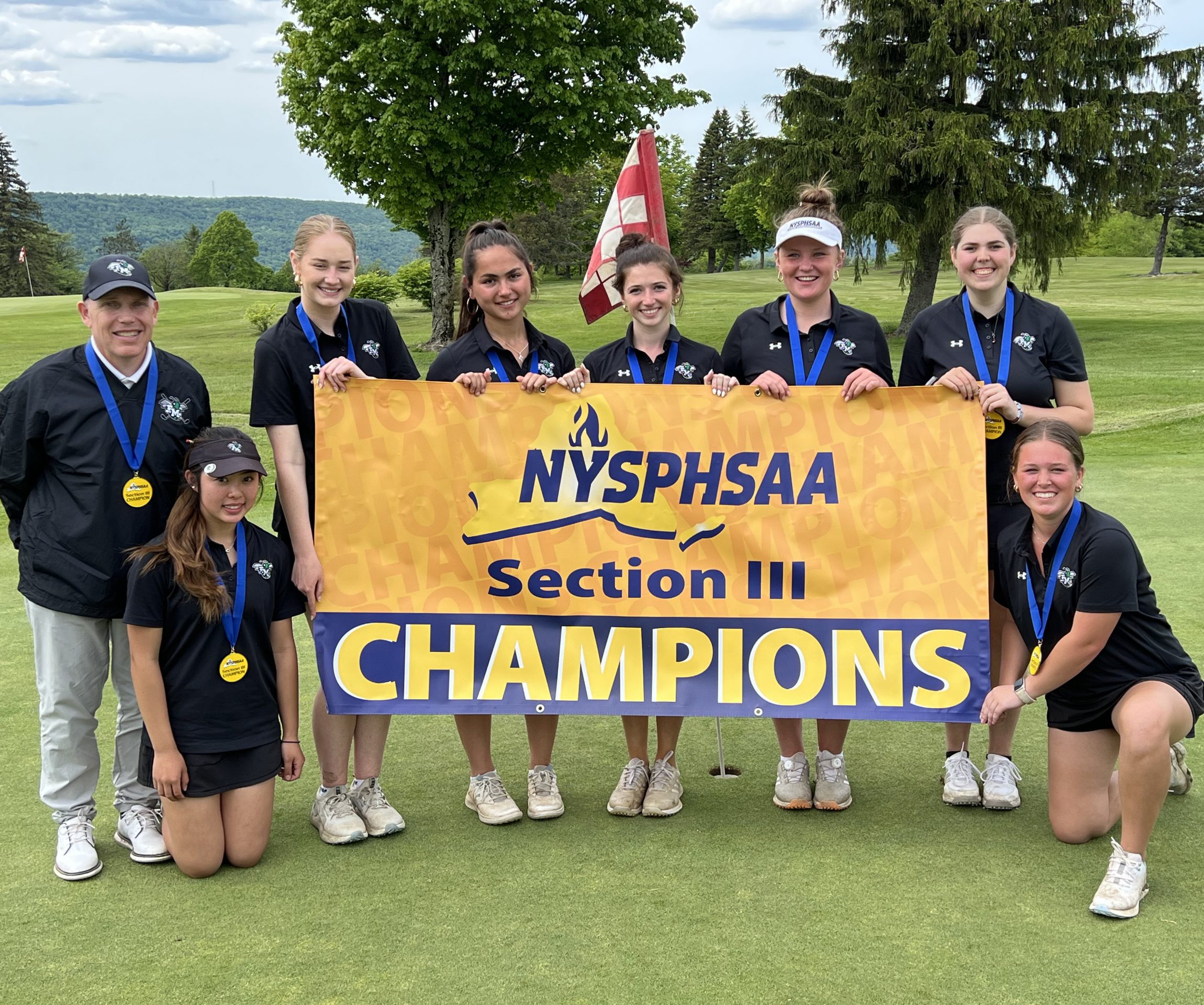 The girls golf team hold a banner indicating they are NYSPHSAA Section III Champions.