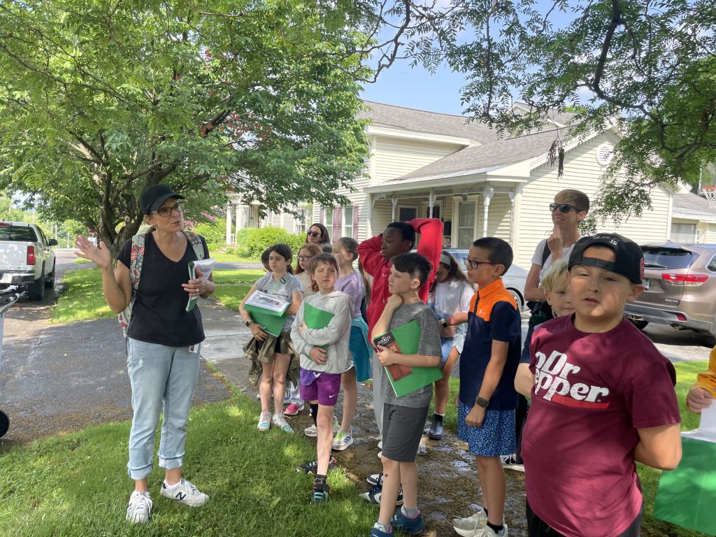 Students on sidewalk during walking tour of Fayetteville.