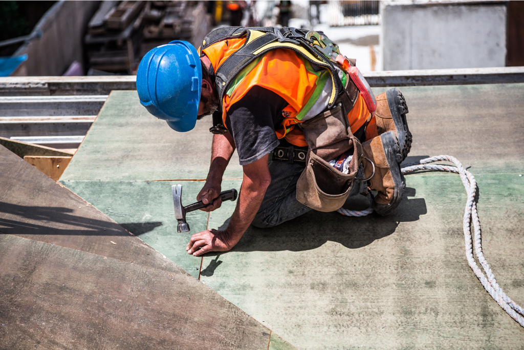 A construction worker working on the roof of a building