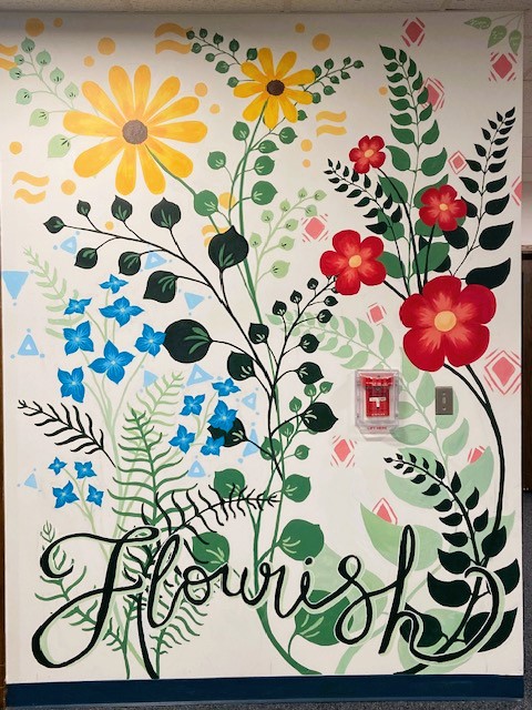 Colorful painting of flowers and the word flourish.