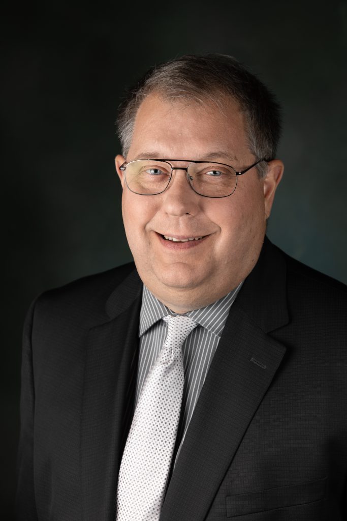 headshot of Dr.Tice wearing a suit and tie