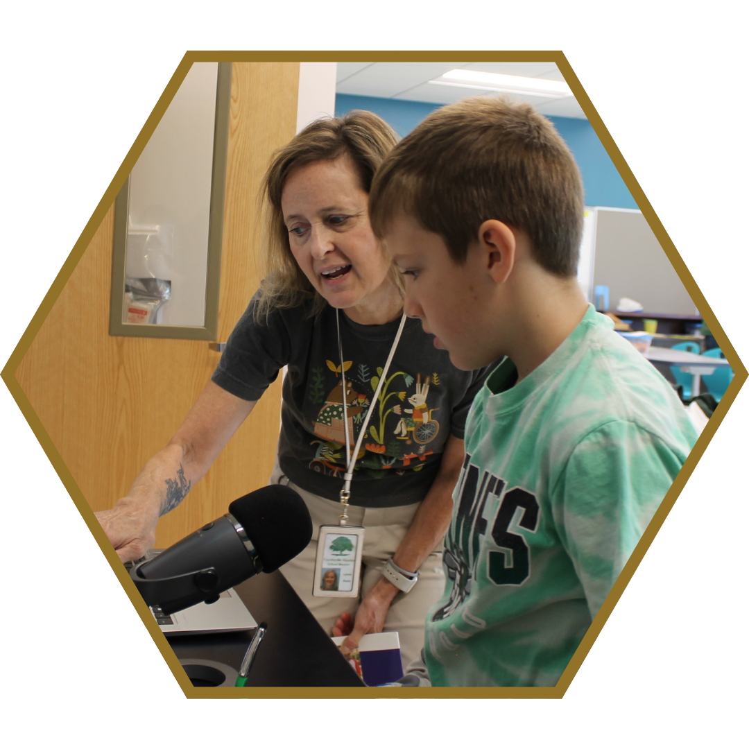 a teacher helping a student on the computer
