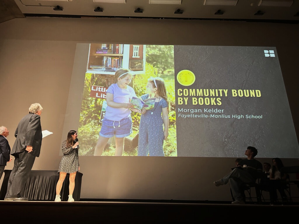 Morgan Kelder on stage during photography award event.