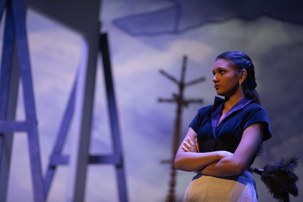 Student performer crosses arm and loos to the side.