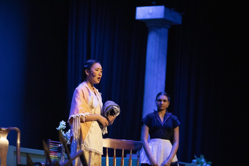 Two students perform on stage.