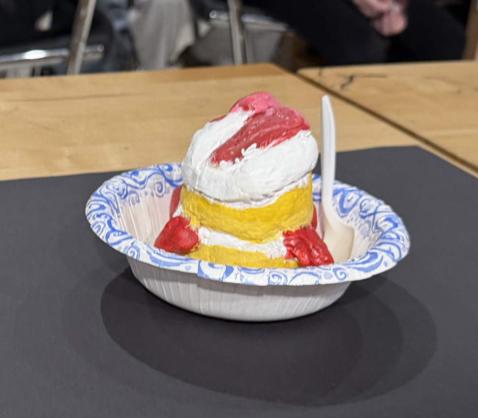 Sculpture of strawberry shortcake in a blue and white bowl