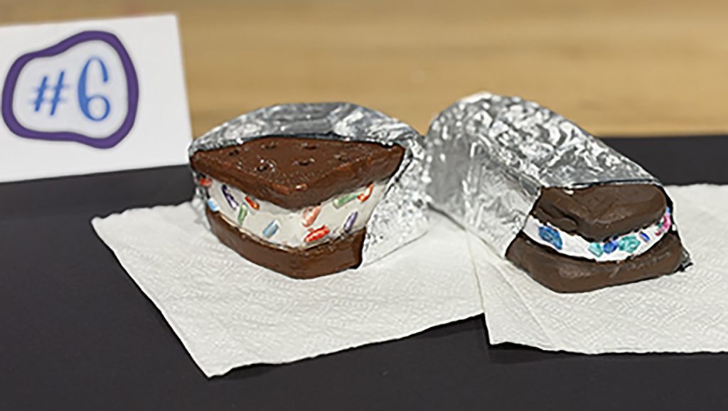 Scul[ture of an ice cream sandwich partially wrapped in foil