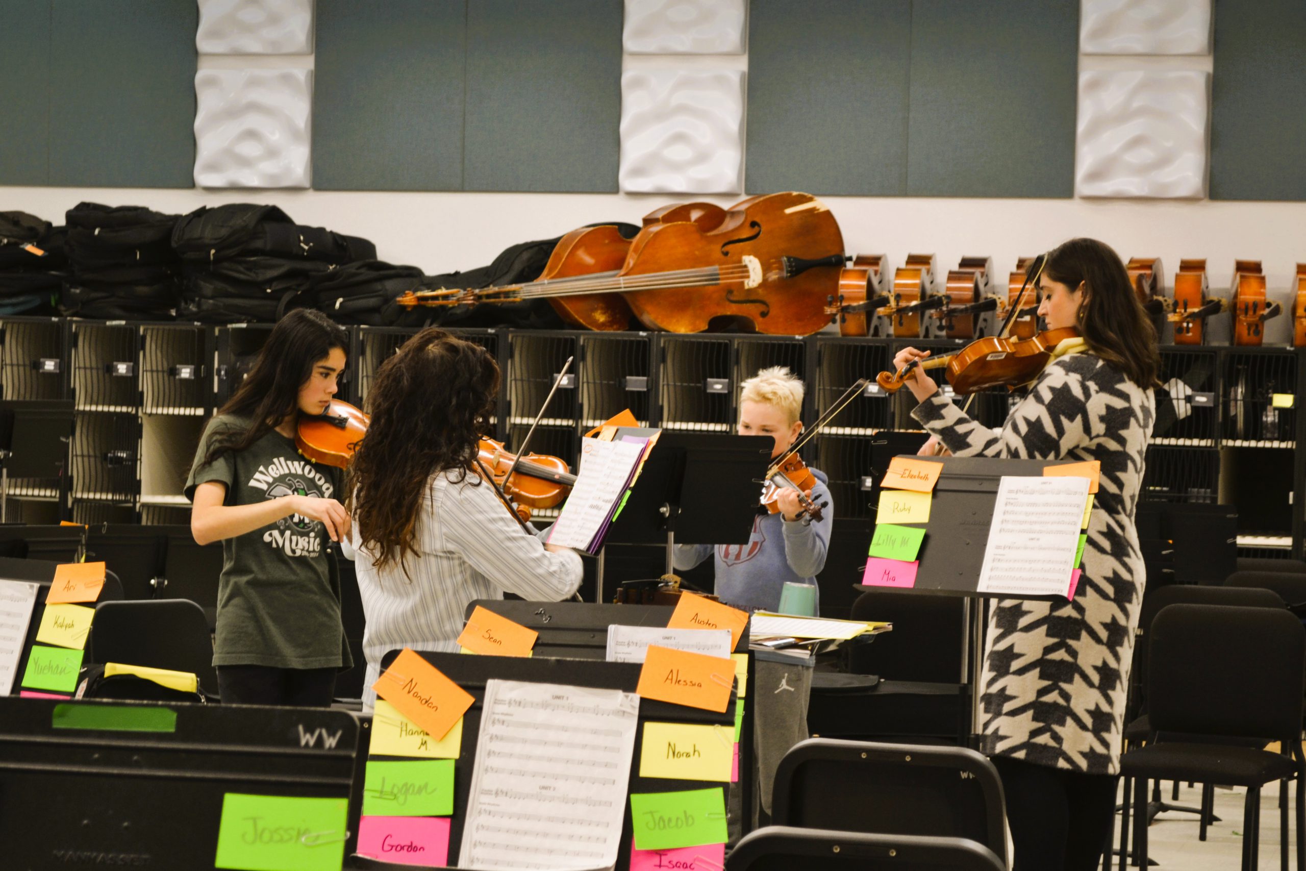 Students practice playing instruments in classrooms.