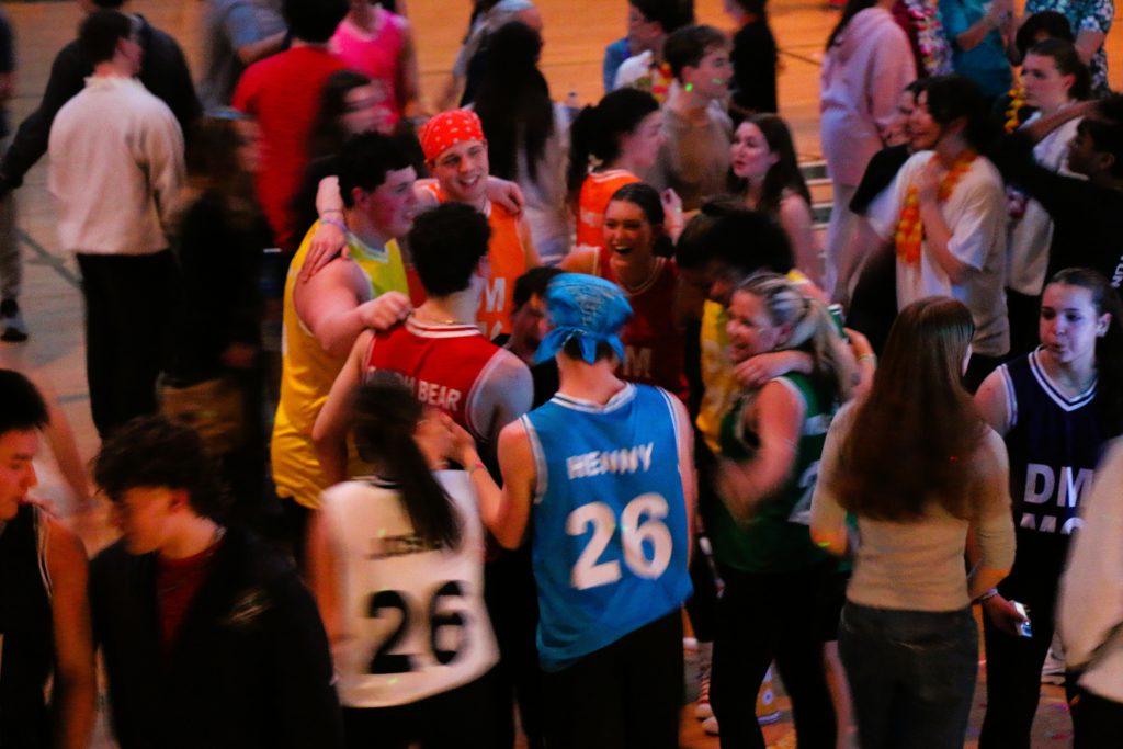 A bird's eye view of students dancing in high school gym.