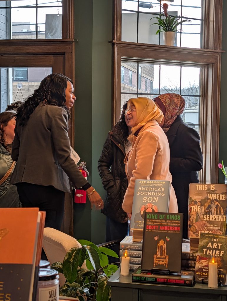 Dr. Parvey speaks with woman at meet and greet at book shop.