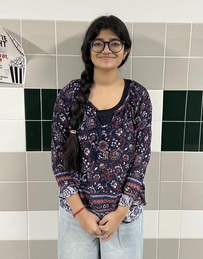 Sureeta Das poses for photo in hallway.