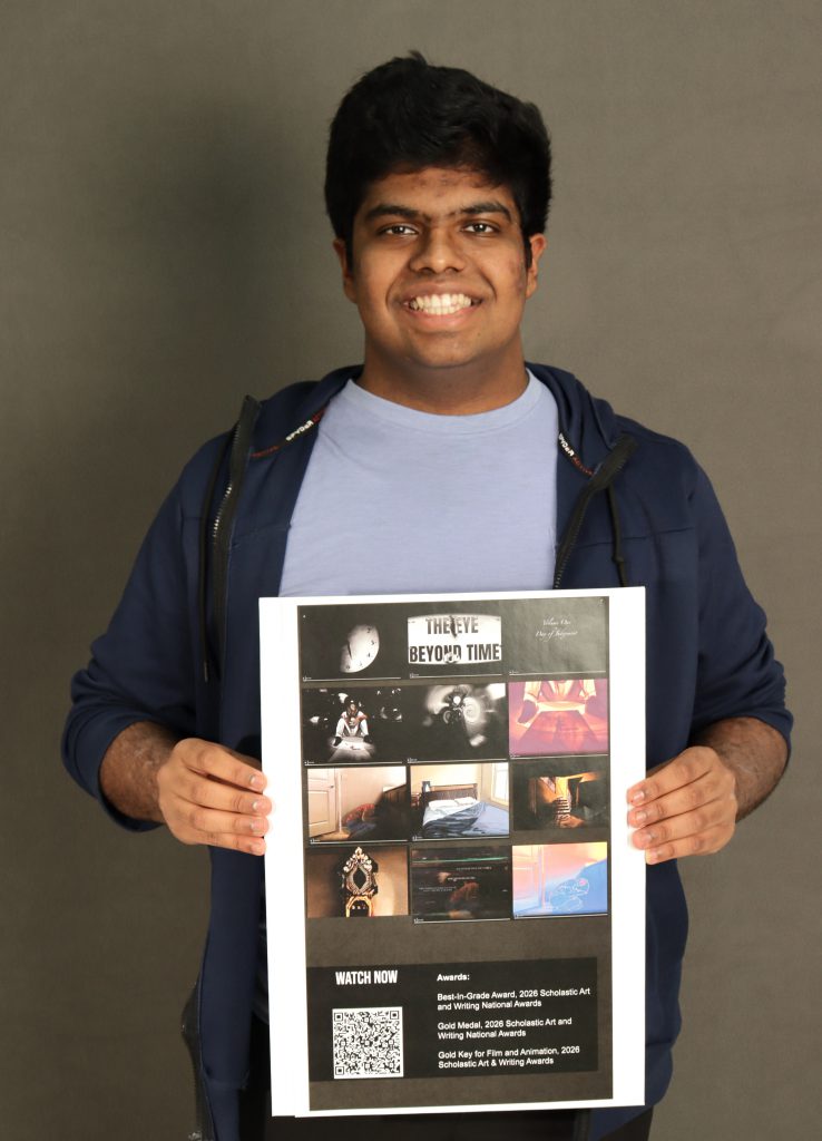 Student holding a poster in front of their body