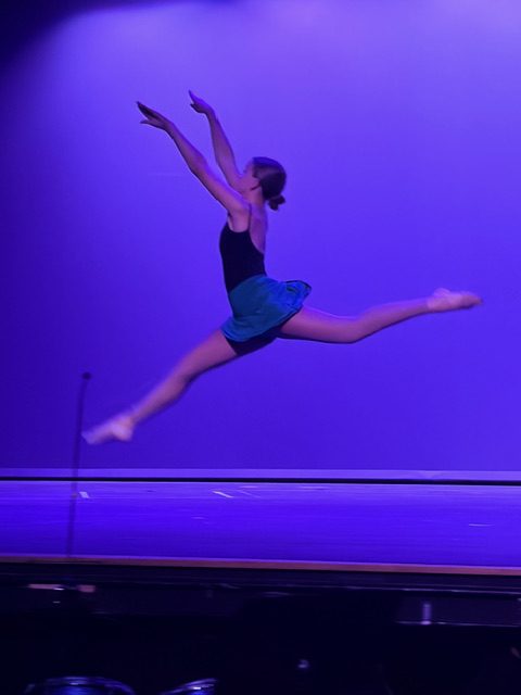 Female dancer leaps in the air.