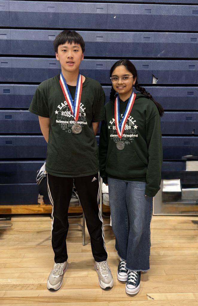 Two students wearing medals