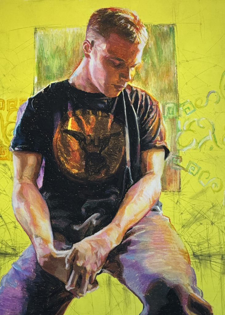 Student artwork featuring a male with short blond hair seated on a stool wearing a t-shirt and jeans with his head tilted down toward his left