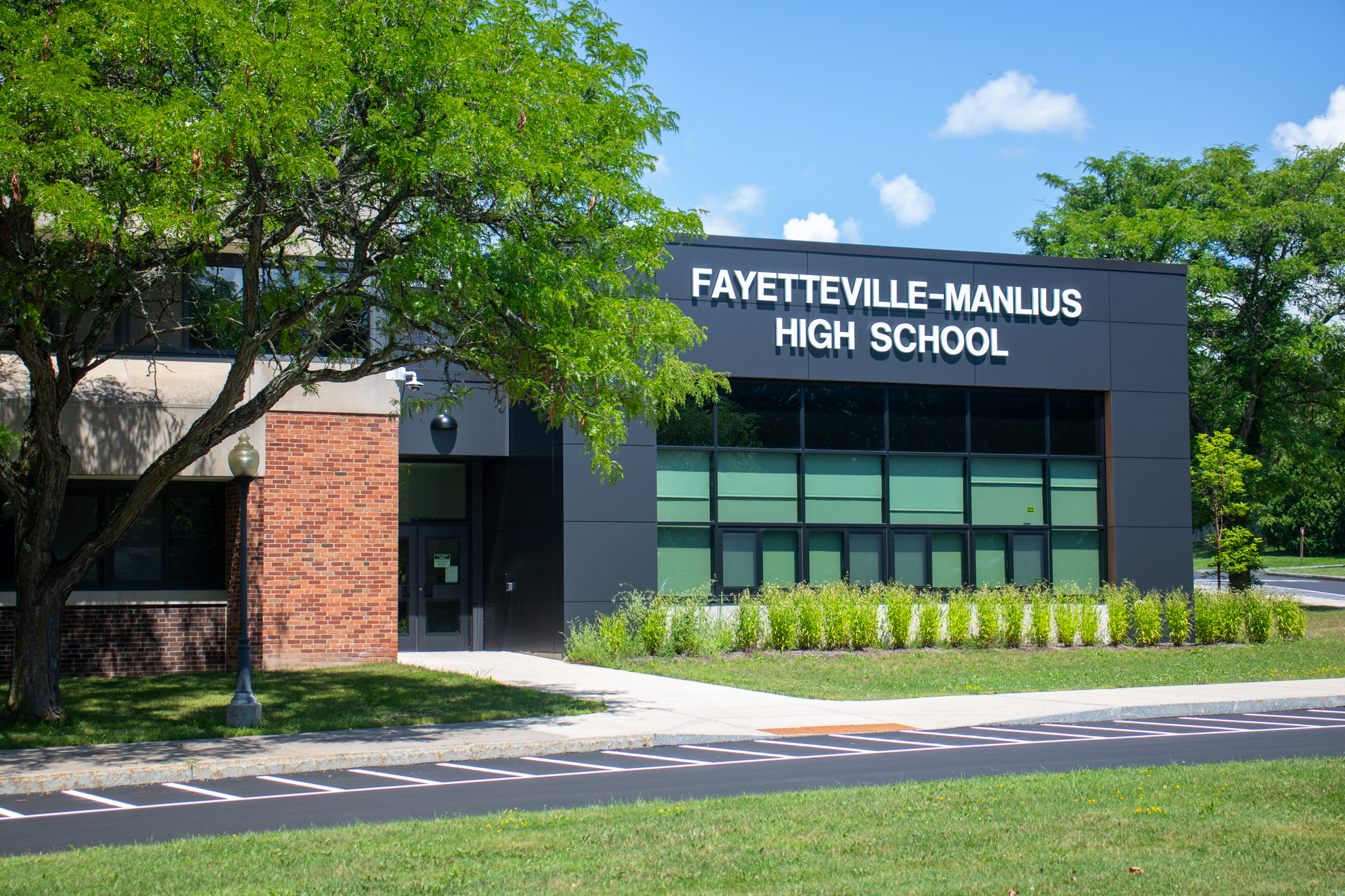 the side of a building with text that reads fayetteville-manlius high school